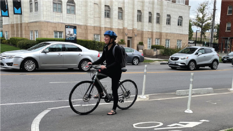 Cyclist breaks at intersection while riding along dedicated bike lane